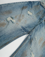 ヴィンテージのダメージ加工ウォッシュジーンズ