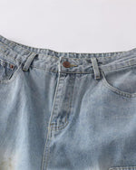 Distressed ripped denim trousers