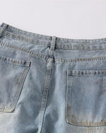 Distressed ripped denim trousers