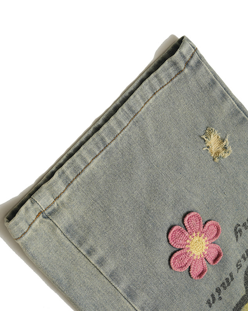 Distressed denim trousers