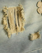 Distressed denim trousers