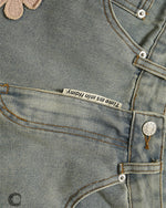 Distressed denim trousers