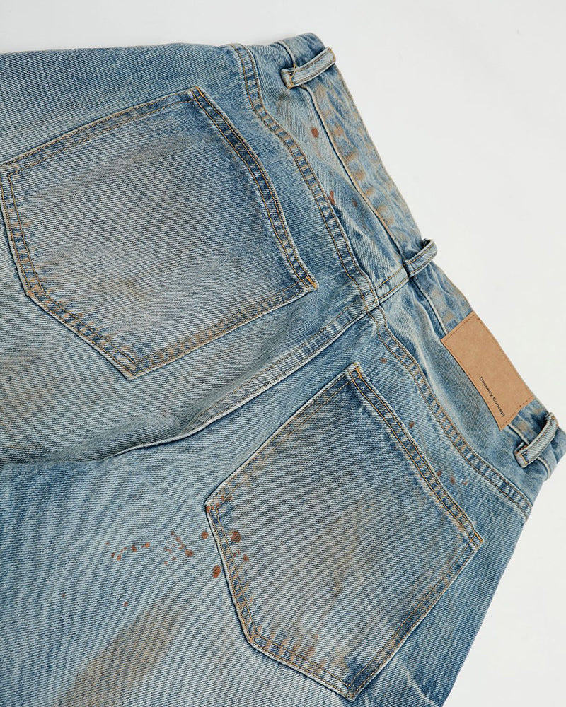 ヴィンテージのダメージ加工ウォッシュジーンズ