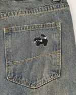 Washed distressed cartoon denim trousers