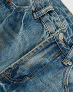 ヴィンテージのダメージ加工ウォッシュジーンズ