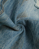 ヴィンテージのダメージ加工ウォッシュジーンズ