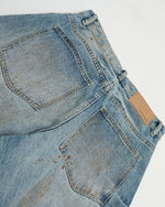 ヴィンテージのダメージ加工ウォッシュジーンズ